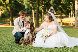 A couple pose with their German shorthair dog during their wedding at 1684 Venue + Resort in Cookson, Oklahoma.