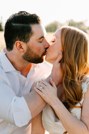 A couple pose for their engagement session at Catoosa Sunflower Field in Catoosa, Oklahoma.