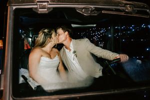 A couple kiss during their wedding sendoff at 1684 Venue + Resort in Cookson, Oklahoma.