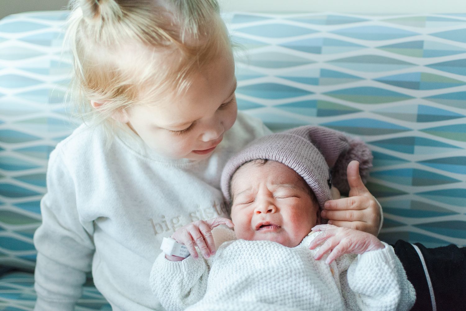 Big sister listens to baby's new cries in a real-life hospital session capturing the first 48 hours.