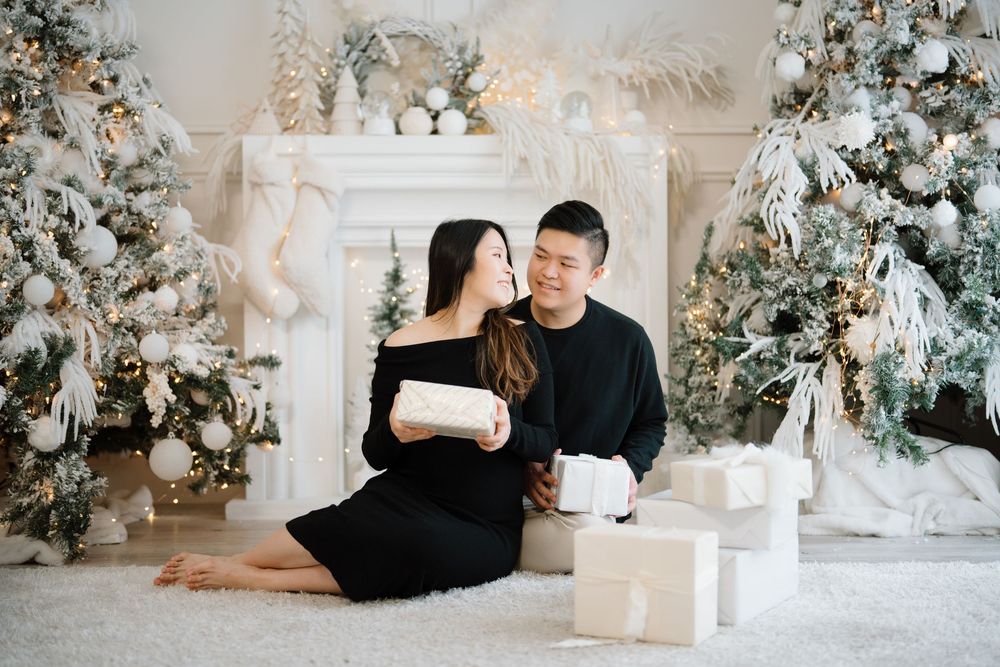 Six holiday photos show a flocked Christmas tree and present unwrapping session against a white and beige backdrop.