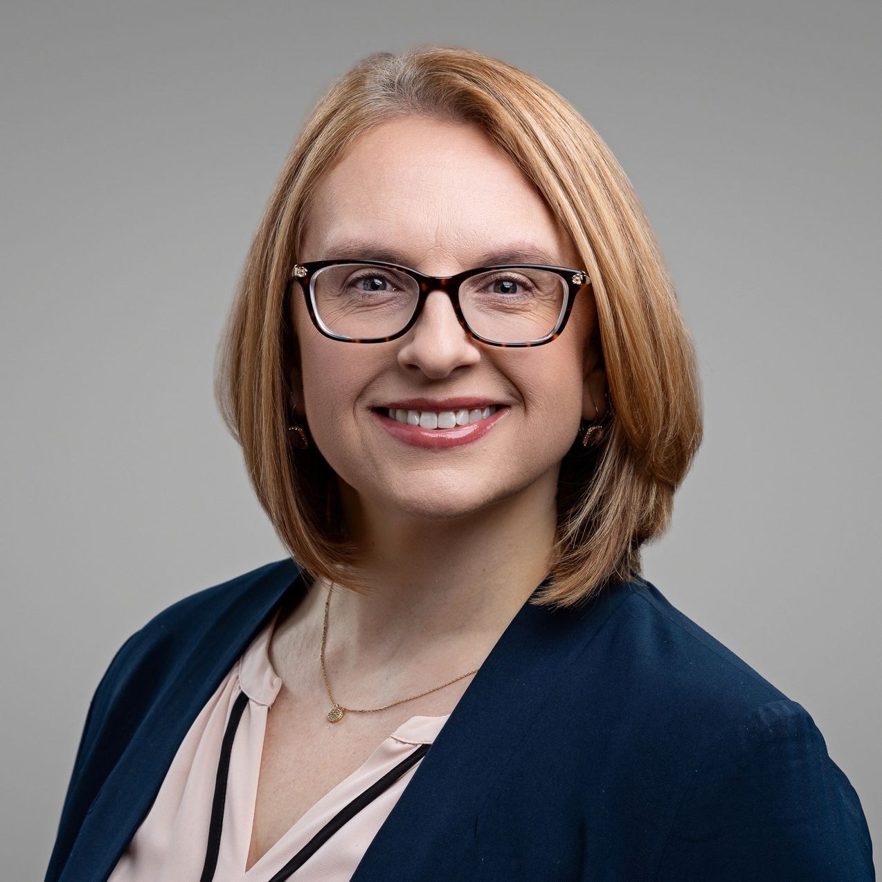 Series of professional headshots against neutral gray background.
