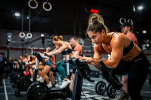 Multiple athletes training simultaneously in modern fitness facility.