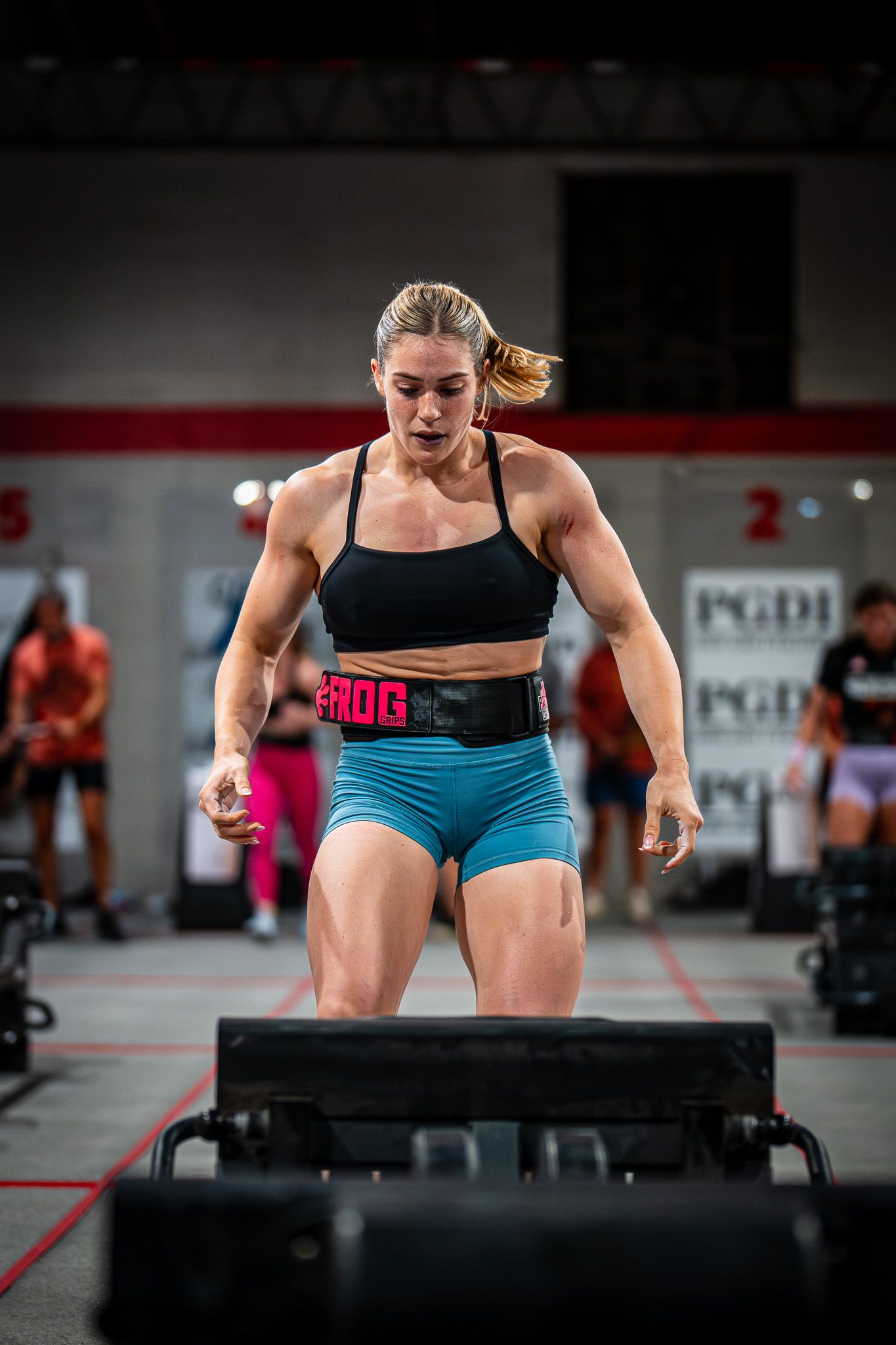 Athletes performing box jumps during an intense workout session.