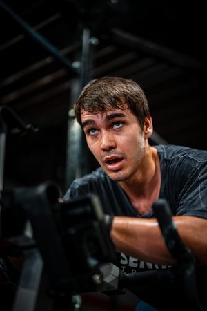 Intense workout session captured in dramatic gym lighting.