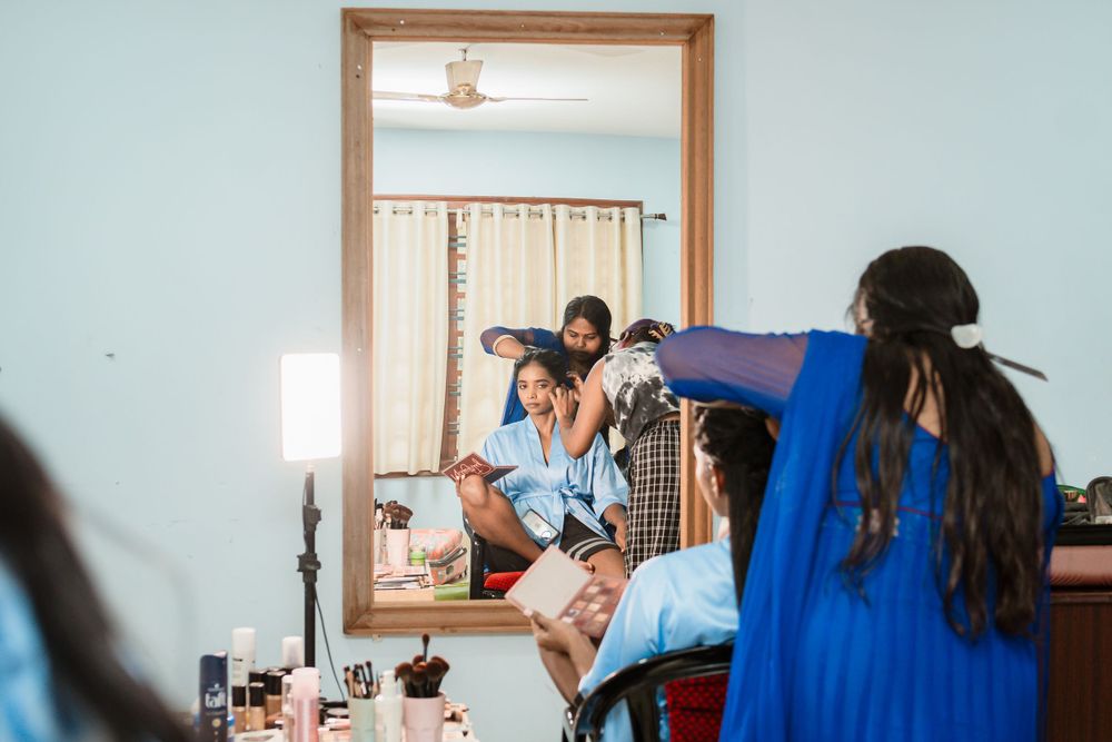 Behind the scenes of bridal preparation with stylists working in a mirror-filled room.
