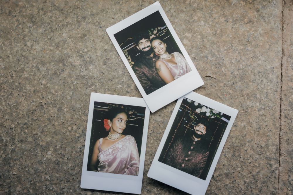 Three polaroid photographs arranged on concrete surface showing wedding moments.