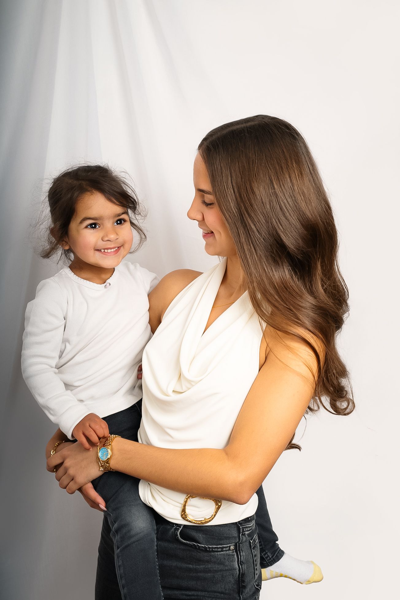 A series of tender family moments captured against a white background showing parent and child interaction.