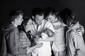 Big family, with 3 teenage boys welcoming their new baby brother, with Mum and Dad.