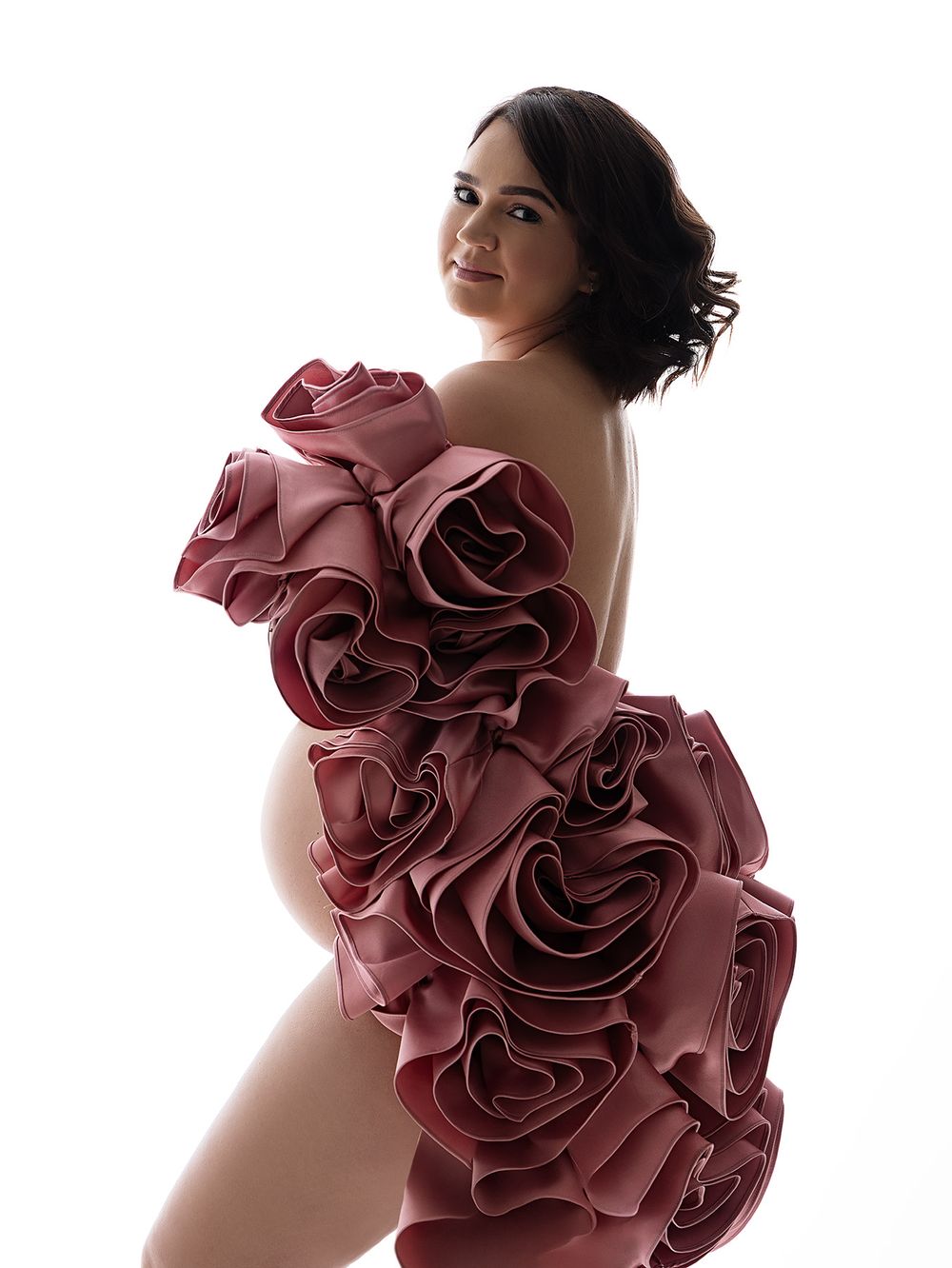 Artistic maternity photoshoot with a dramatic burgundy flower cape in Atlanta photography studio Fine Art House.