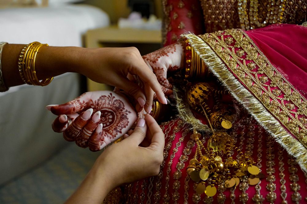 Wedding party in traditional South Asian attire walking together outdoors in formal procession.