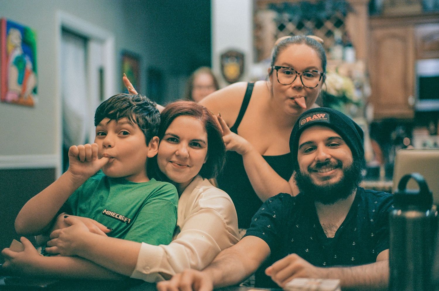 Candid family moment captured in warm tones at a restaurant setting.