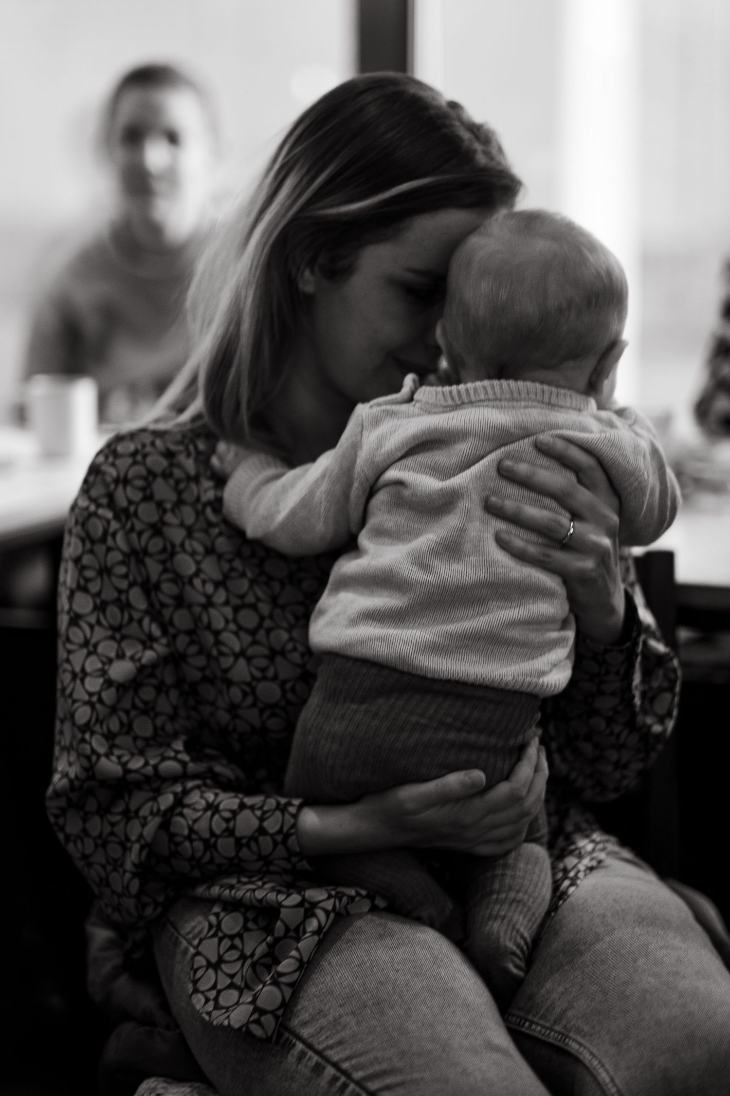a mother touching her baby son with her forehead during networking event in Stockholm while being captured by event photographer