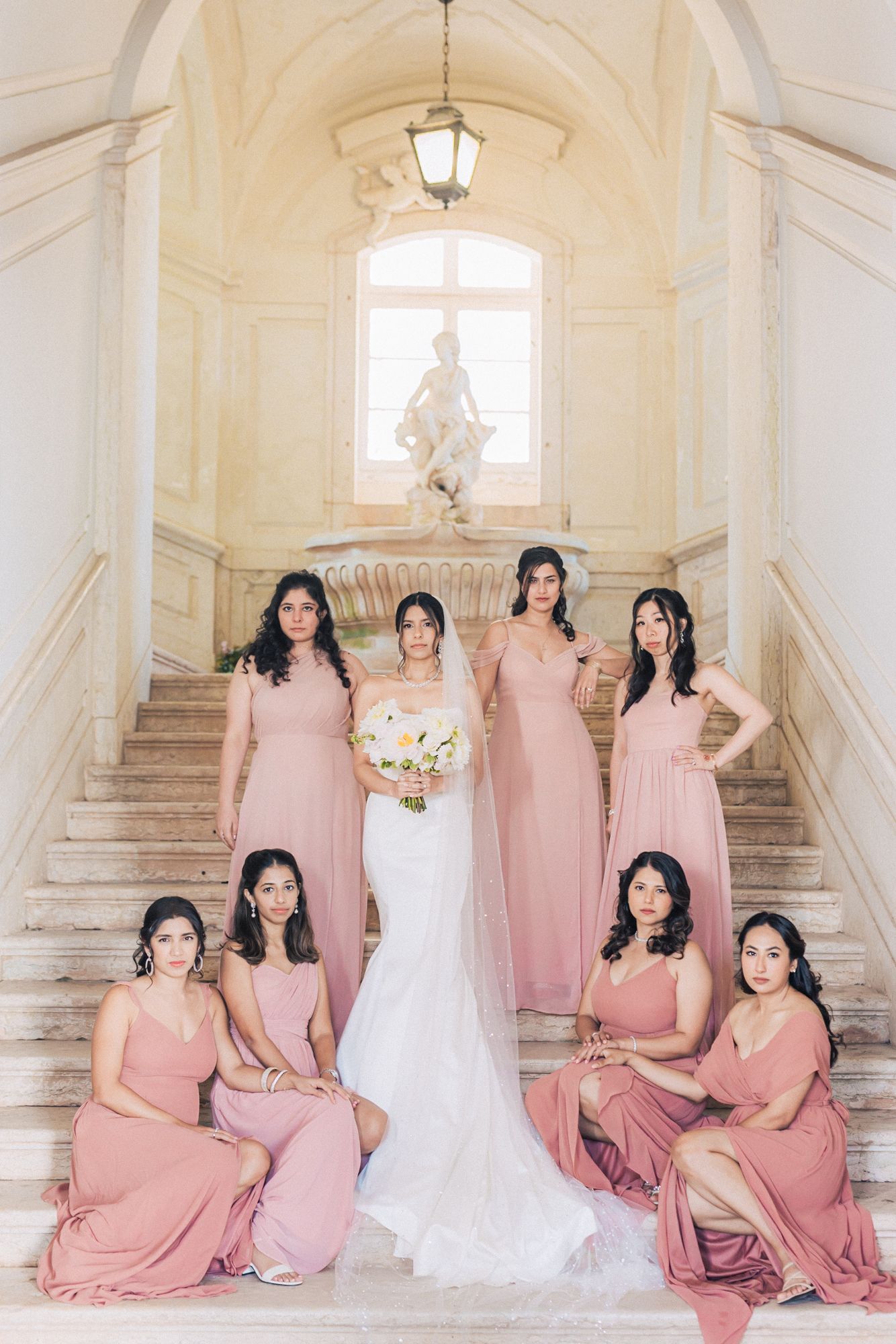 bridesmaids in pink dresses photographed by an Indian destination wedding photographer in Portugal – Correio Mor Palace