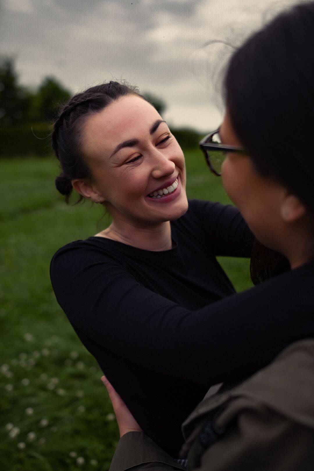 beautiful couple dancing and laughing on their engagement photoshoot on Irish field