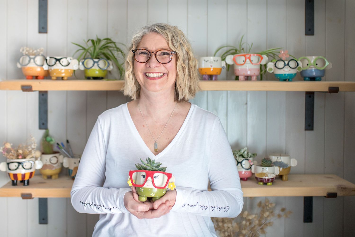 Interior view of a potter decorative succulent arrangements on wooden shelves.
Small Business Storytelling photography