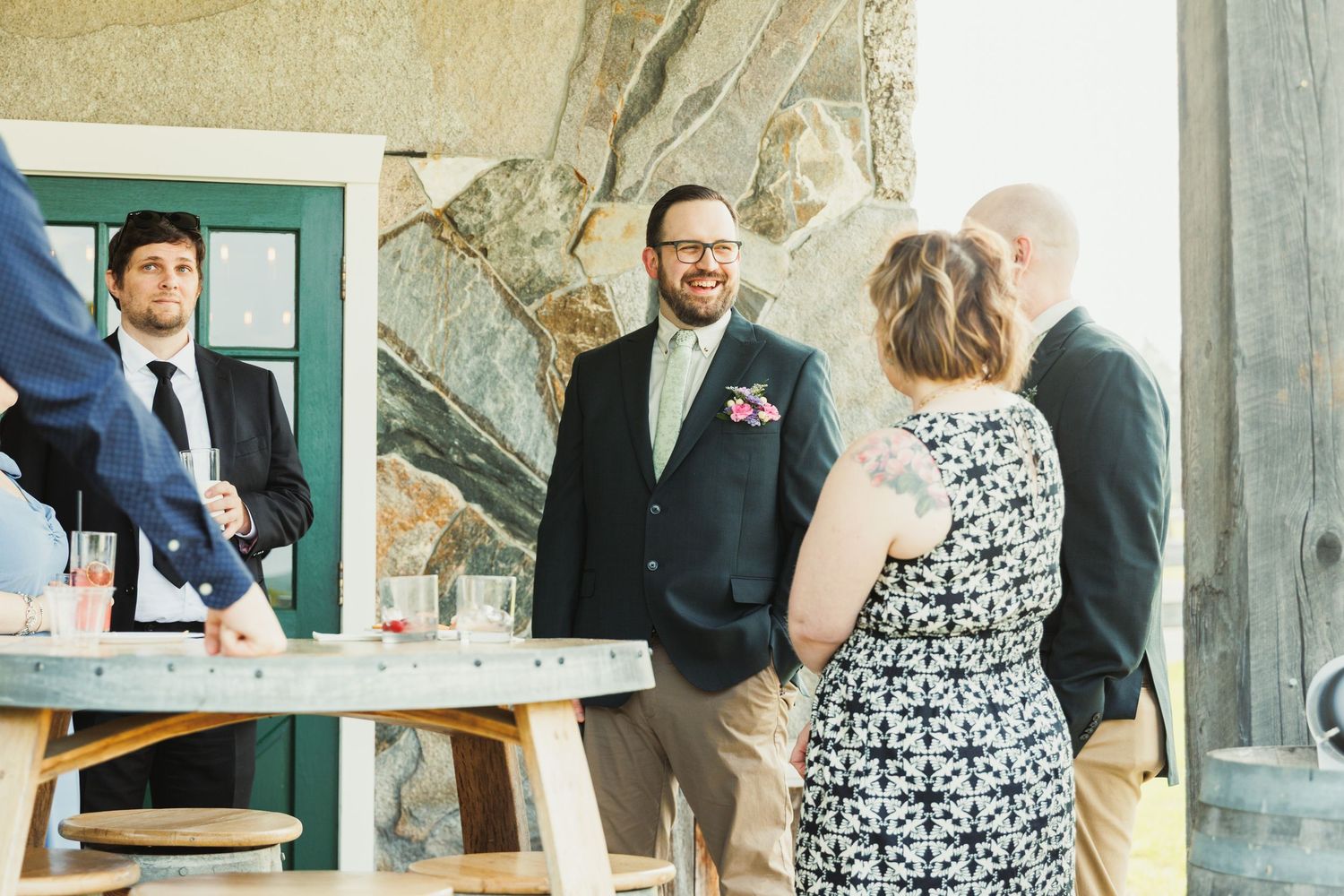 People interacting in a stone-walled venue during a social event.