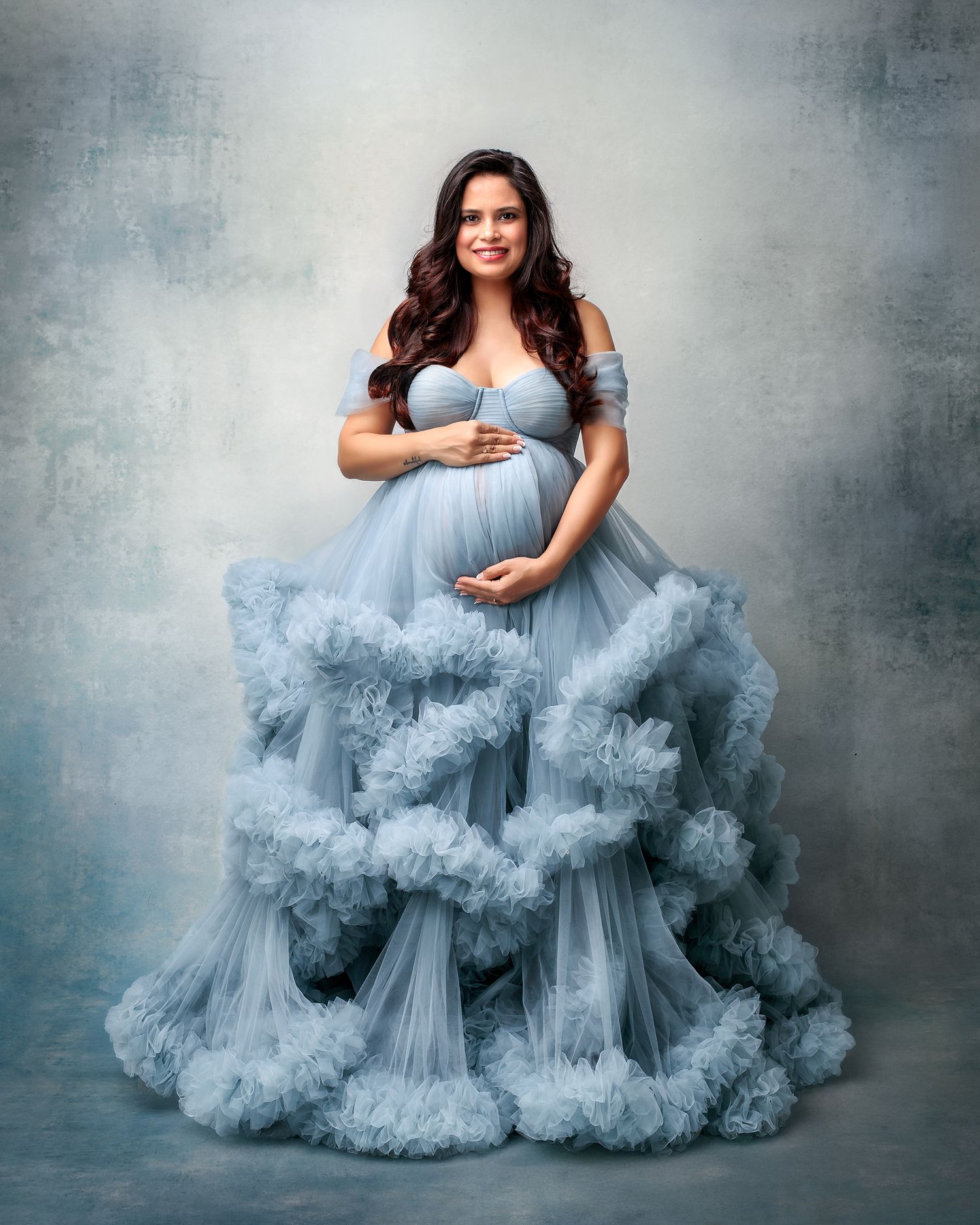 Luxury maternity portraits Sydney: expectant mum in an elegant soft blue gown.