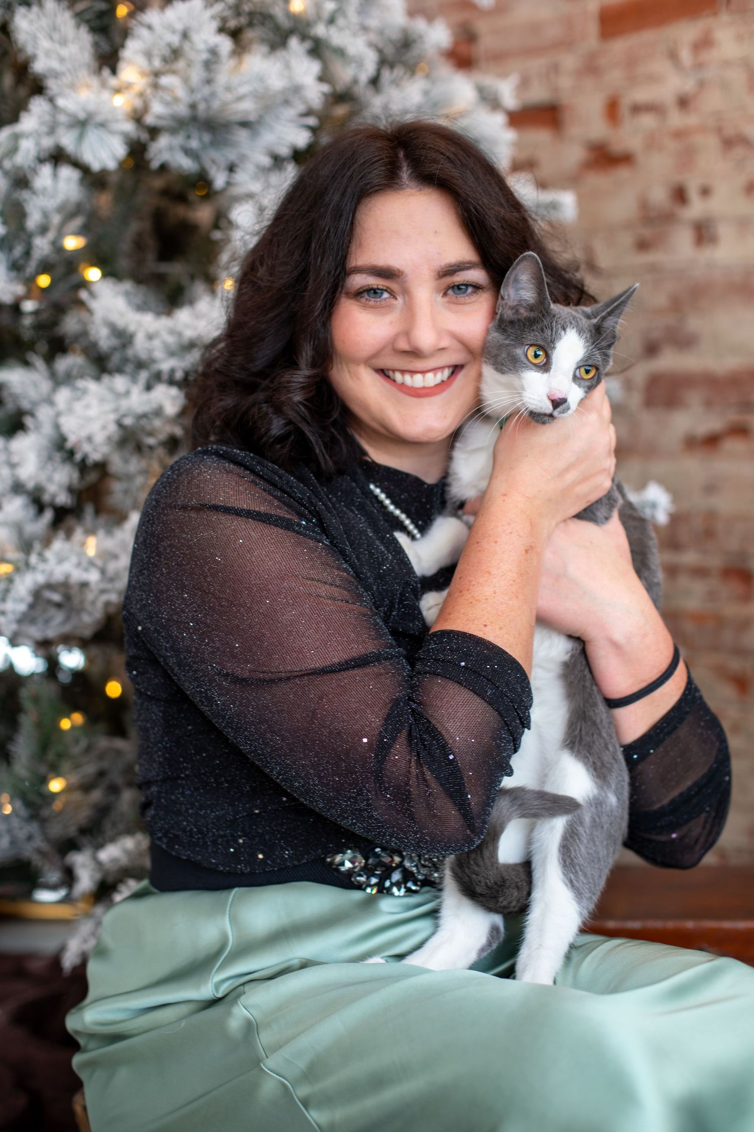 Cincinnati holiday mini session featuring woman and cat Christmas portrait with cozy indoor festive styling and intimate seasonal photograph