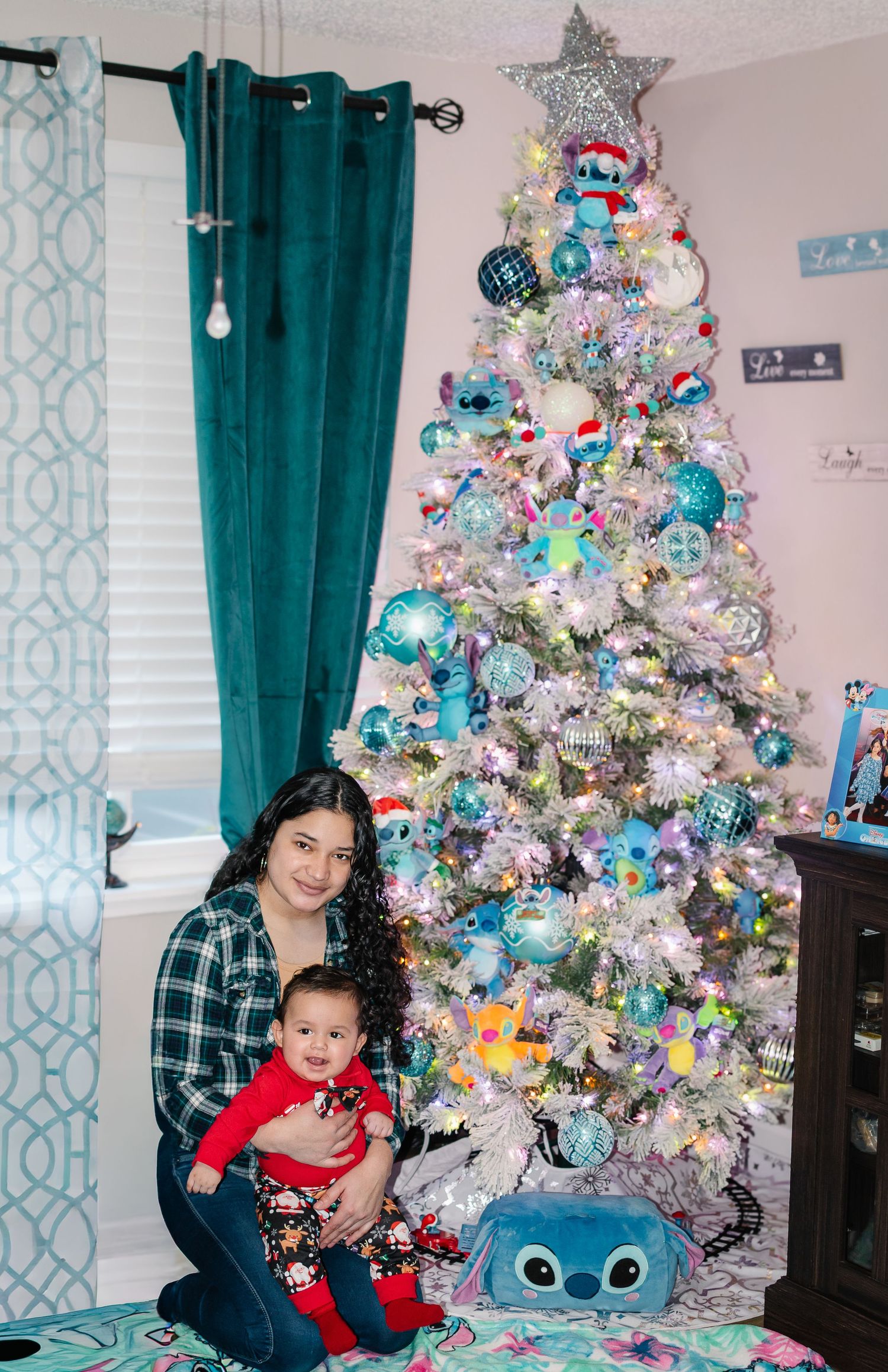 Baby boy photographed by a decorated Christmas tree during an in-home holiday photo session in Puyallup