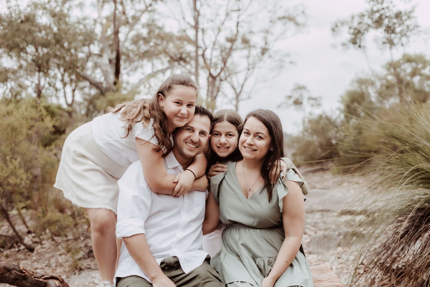 Friends laughing together in a casual outdoor photo session.