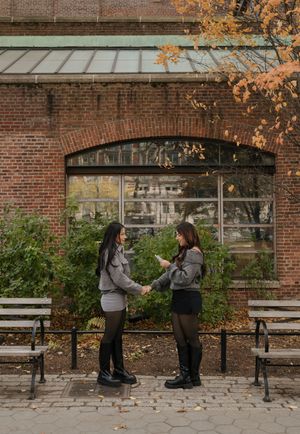 Progressive sequence of two people interacting on stone benches near a brick building.