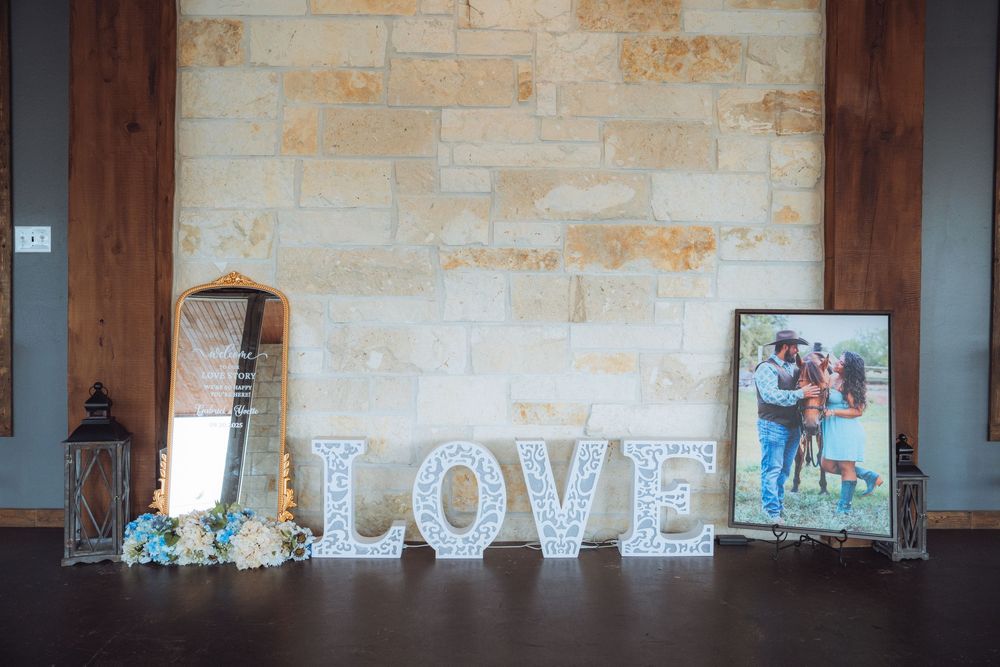 Modern wedding venue interior with stone walls and decorative LOVE letters.