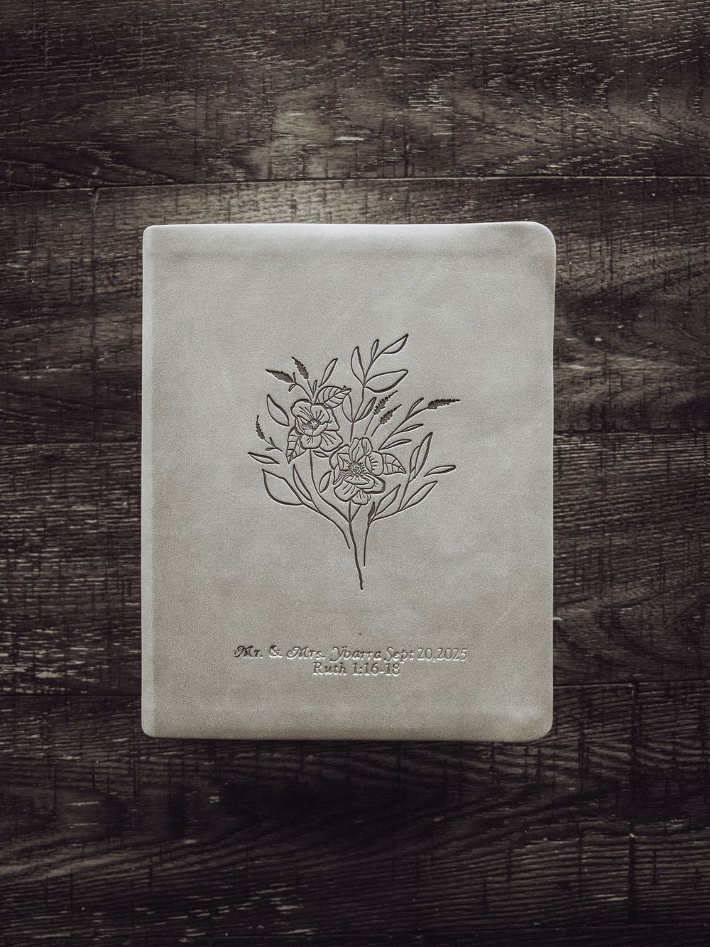 Professional photography business cards with floral design on dark wooden surface.