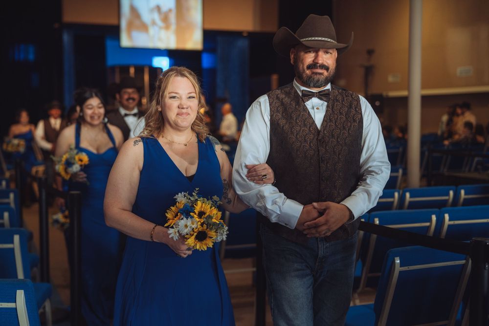 Wedding party members in western attire during indoor ceremony.