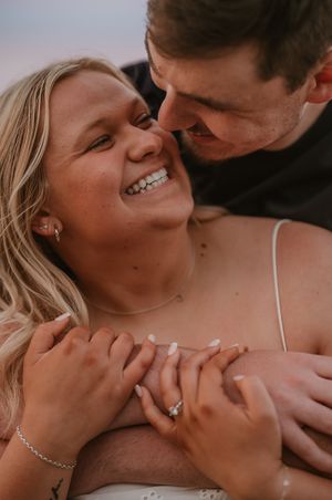 A romantic couple in neutral tones share intimate moments in a beautifully styled photoshoot.