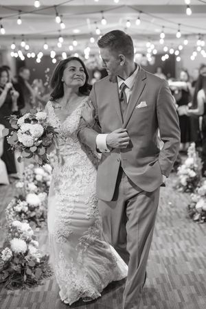Newlywed couple shares romantic dance moments under twinkling lights at their wedding reception.