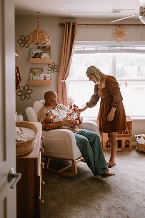 Three sequential shots show a tender indoor moment between people sitting in a cozy living room with warm lighting.