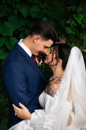A romantic wedding photo series showing tender moments between newlyweds in a garden setting.