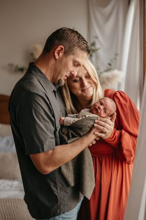 Intimate couple shares tender moments in a series of romantic indoor portraits with soft natural lighting.