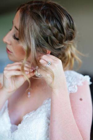 Close-up profile shots of a bride wearing delicate pearl drop earrings and an elegant updo hairstyle.