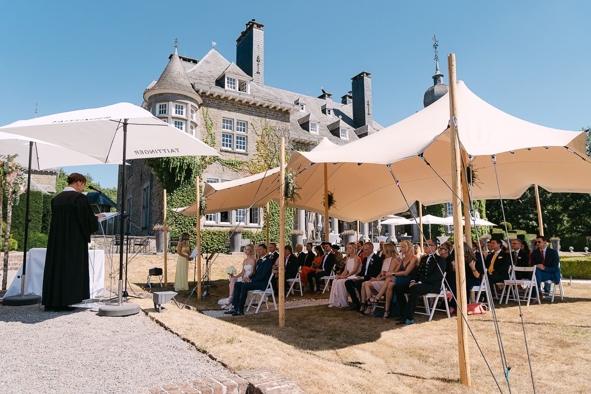 Garden wedding ceremony overview with guests at Manoir de Lébioles