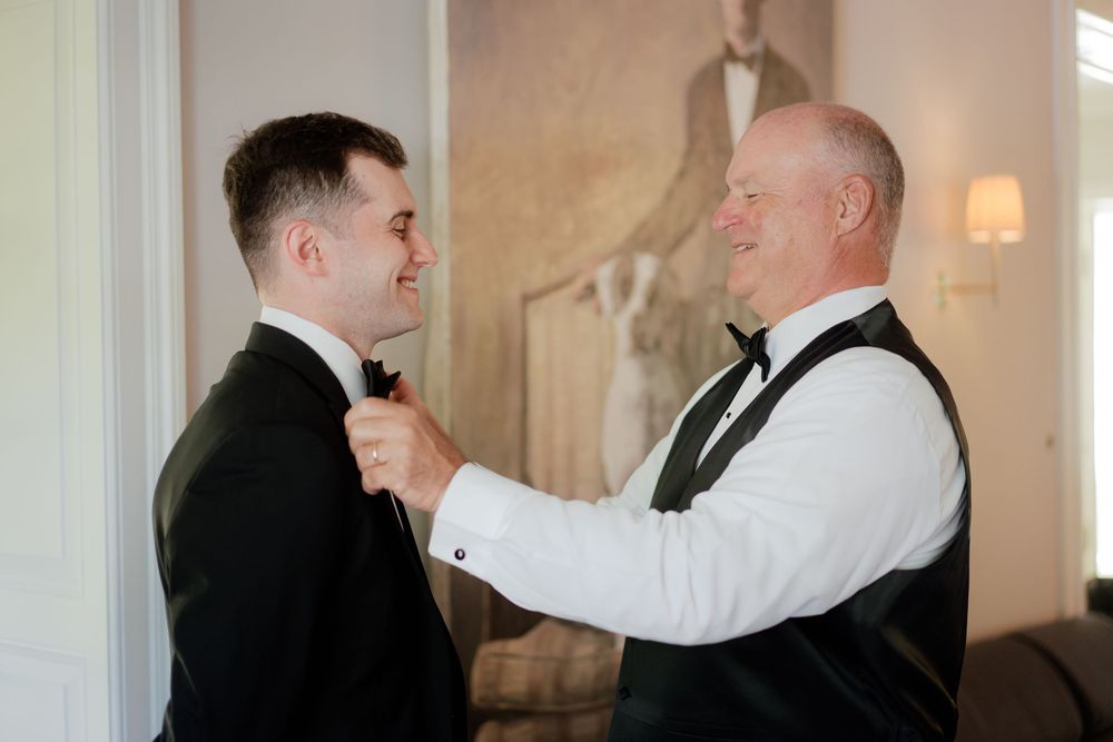 Wedding reception guests sharing heartfelt moments during evening celebrations at an elegant indoor venue.