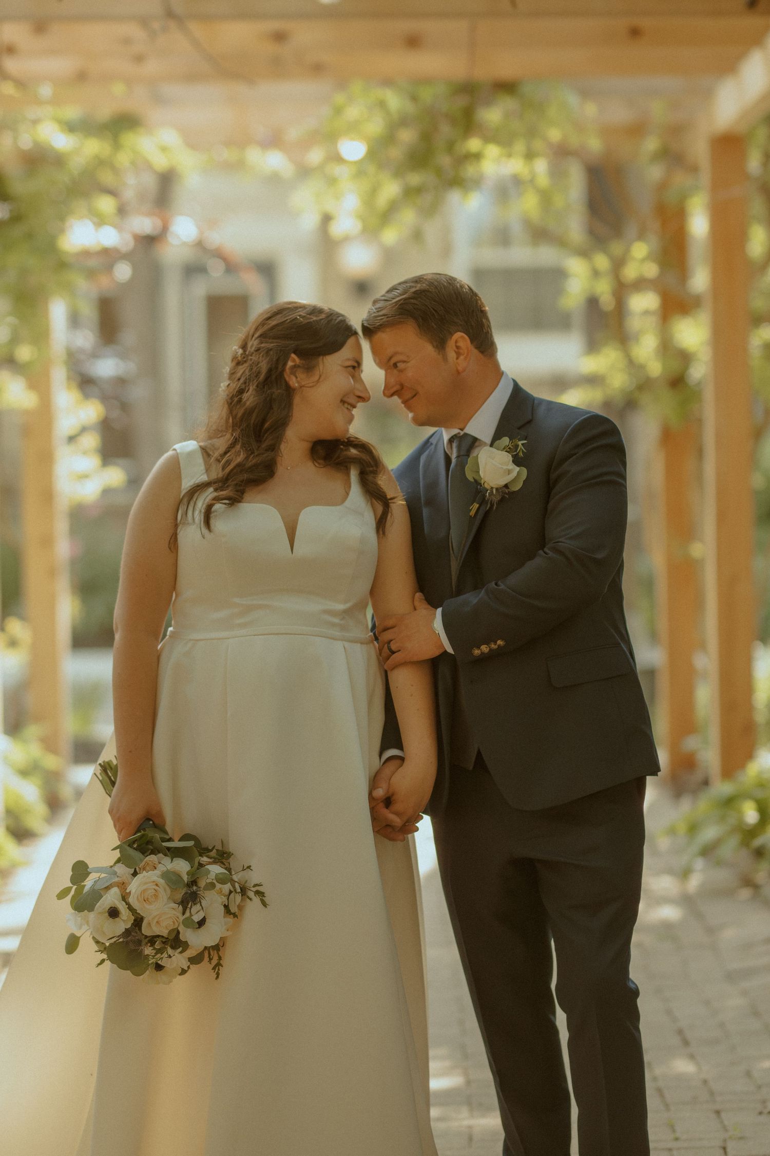 Romantic outdoor wedding moment captured in warm golden light.
