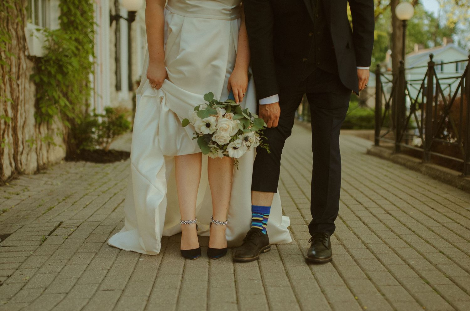 Cropped photo of legs standing on a wooden boardwalk against a blurred natural background.