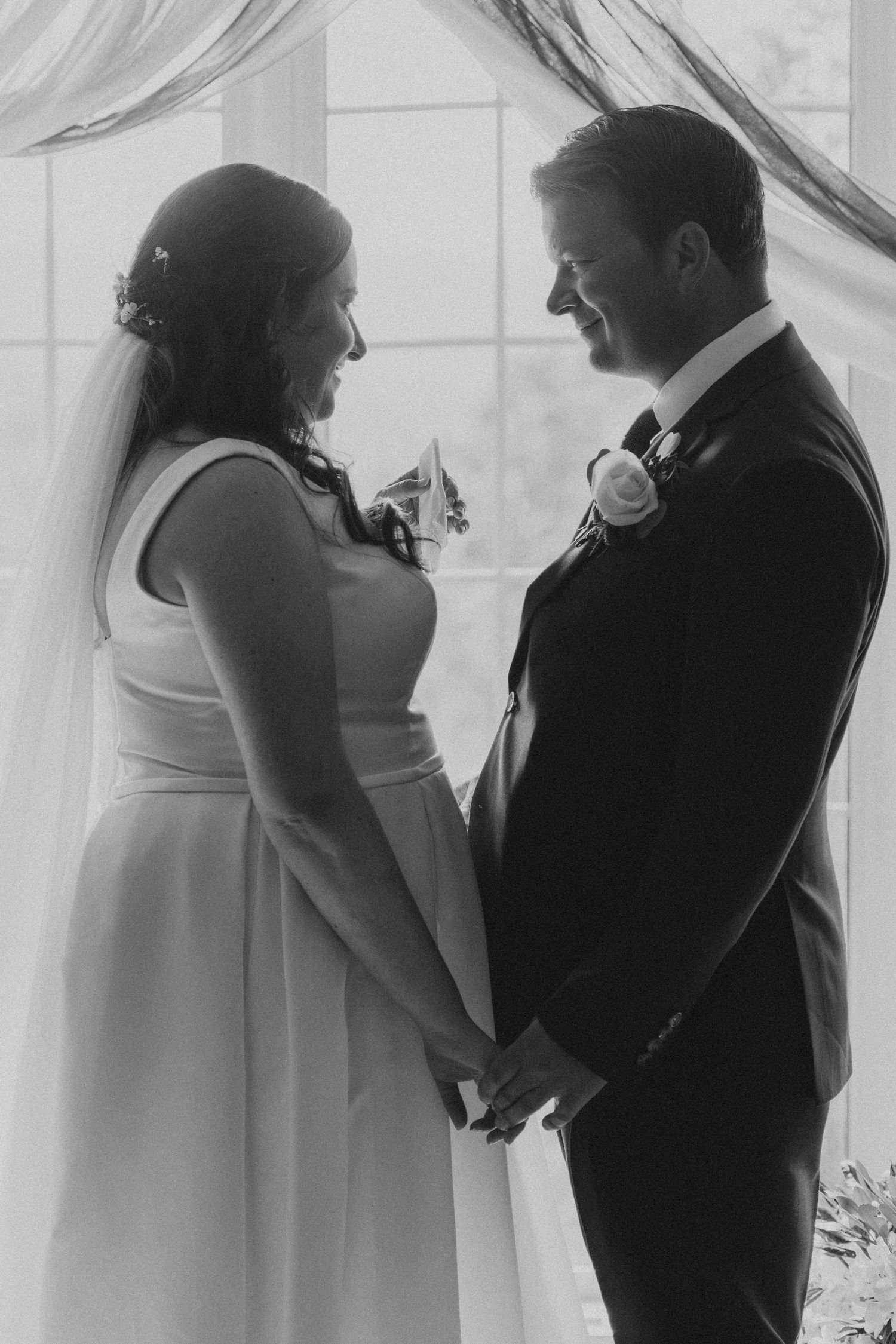 Black and white silhouettes of a couple sharing intimate moments behind sheer curtains.