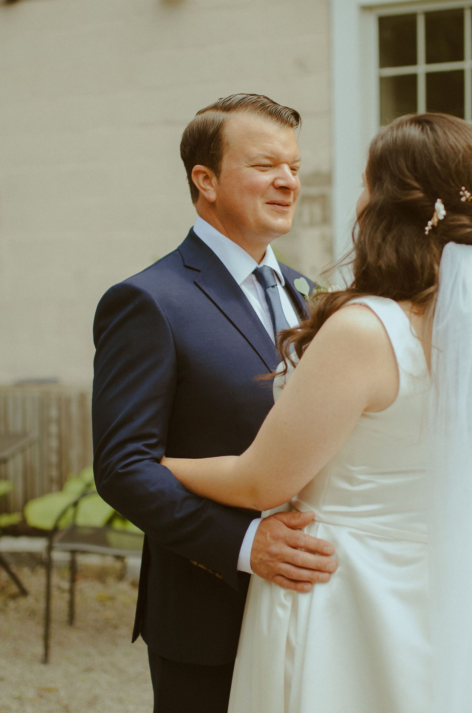 A tender first dance moment captured at a wedding reception between a couple in formal attire.