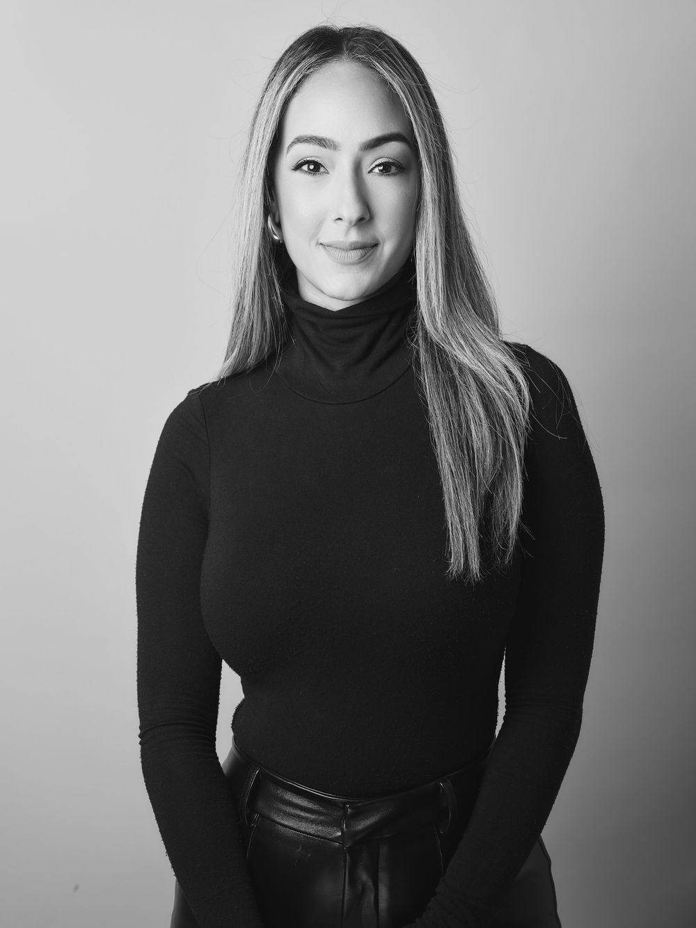 Black and white portrait series showing expressive poses in a black turtleneck against neutral background.