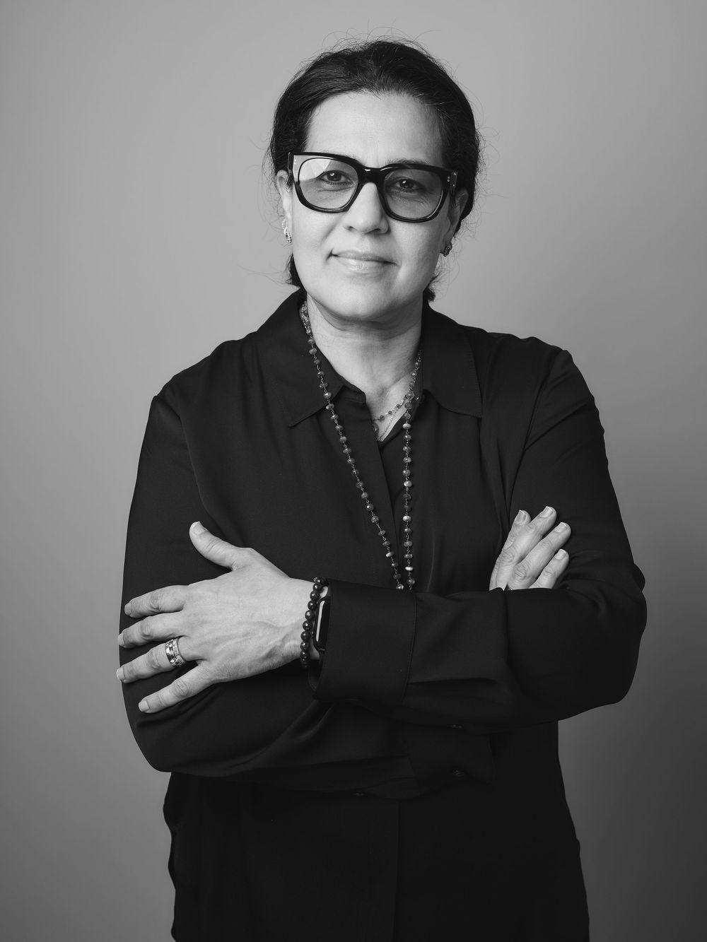 Black and white portrait series showing a person in dark clothing and glasses making expressive gestures against a plain background.