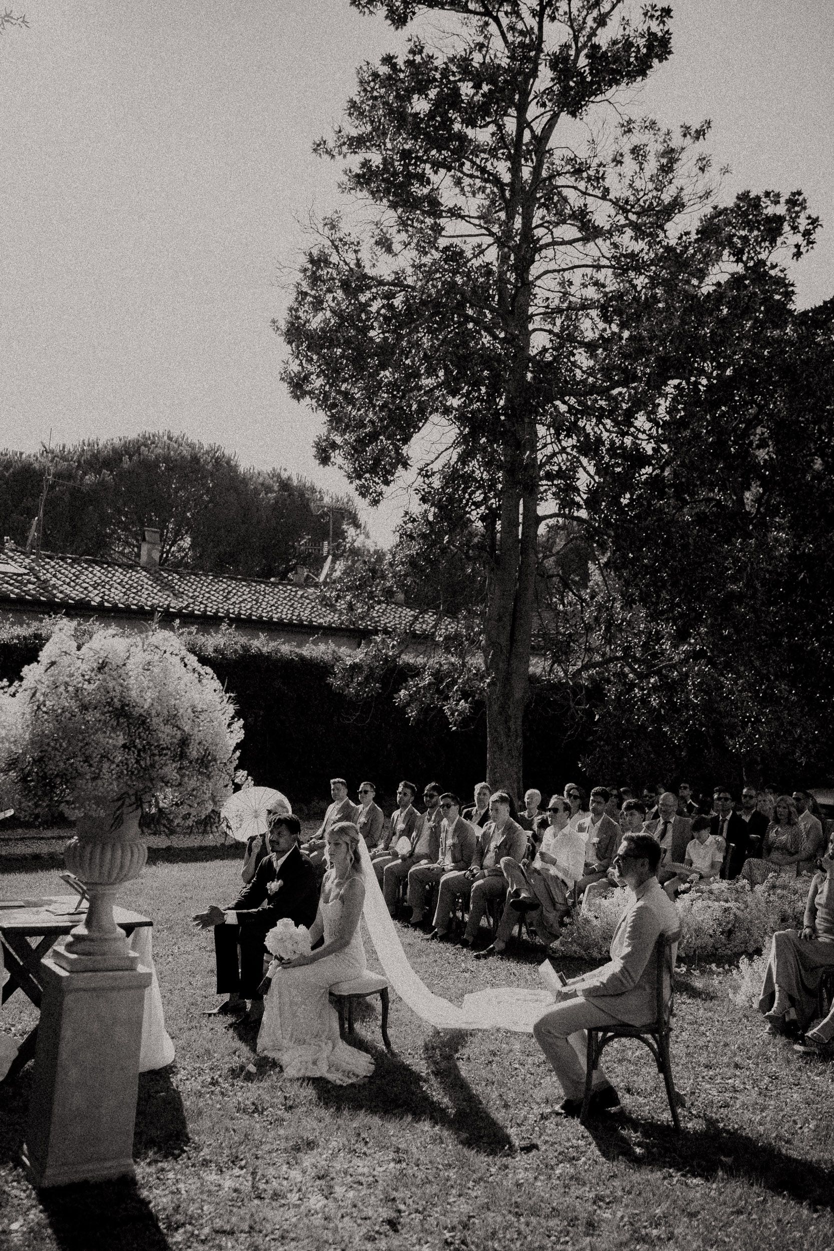 A series of vintage black and white photos showing people dancing and playing on wooden barrels in an outdoor setting.