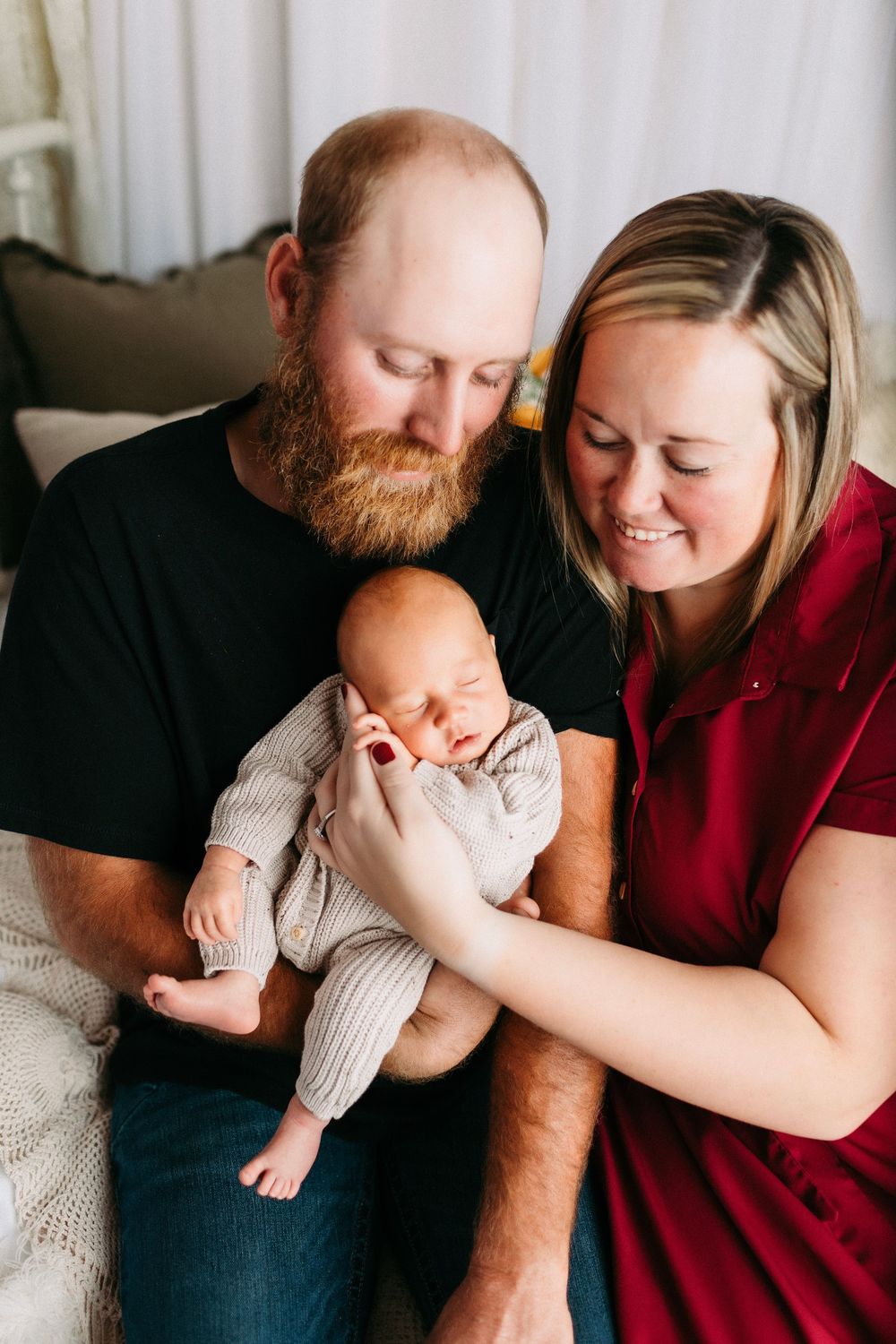 A family shares tender moments together on a couch, showing emotional togetherness in a series of intimate poses.
