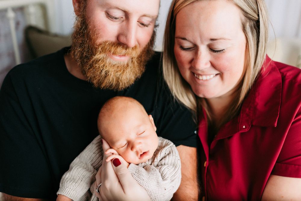 A collection of candid family photos showing tender moments between parents and their newborn baby at home.