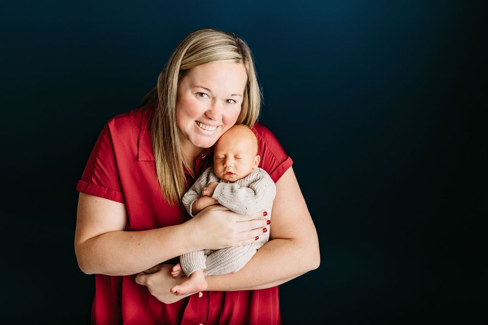 A collection of tender newborn photography portraits featuring a baby in casual poses with red and dark backgrounds.