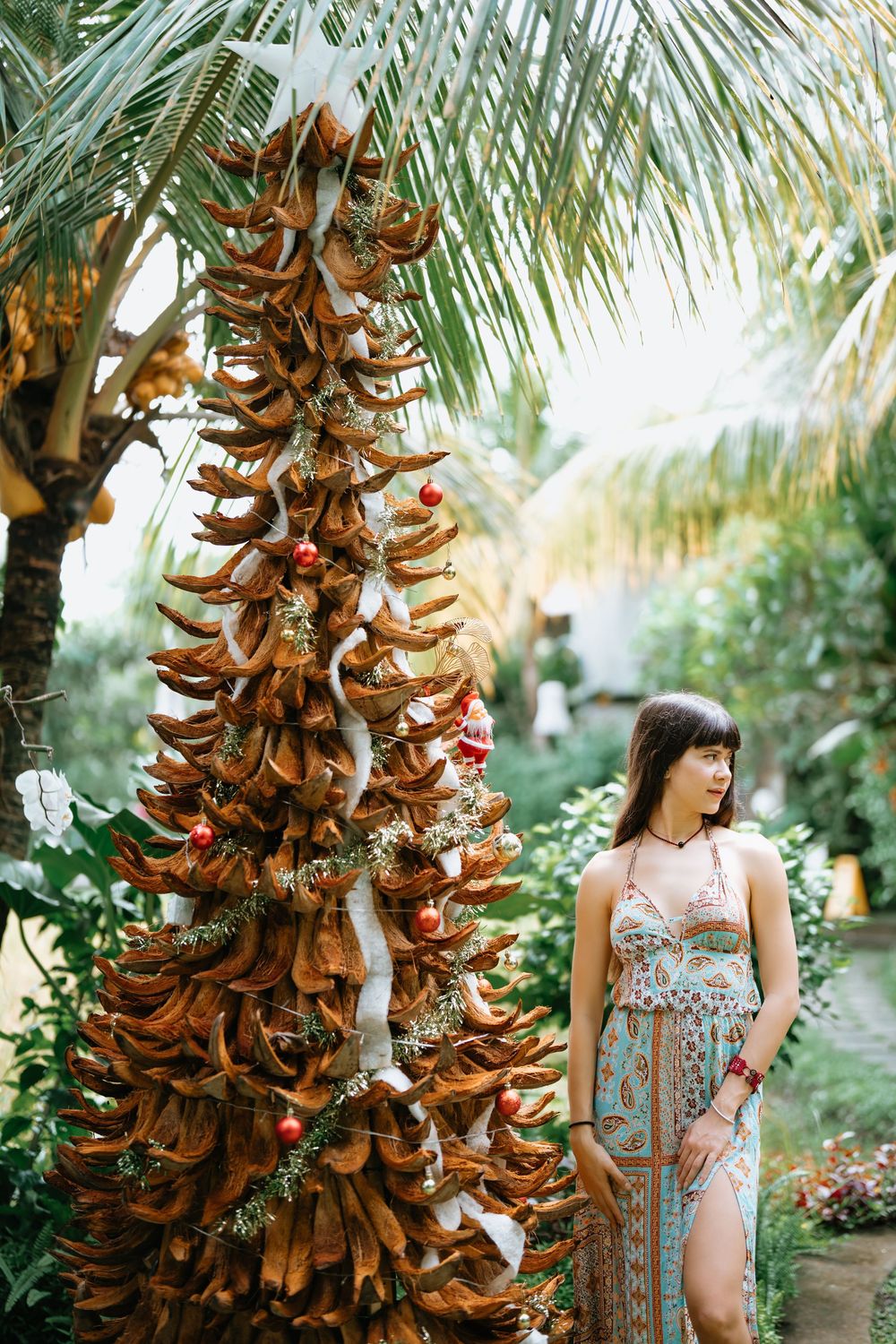 Artistic portraits among dried palm fronds and tropical foliage in a garden setting.