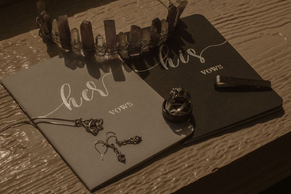 Elegant wedding stationery and cards laid out on a rustic wooden table.