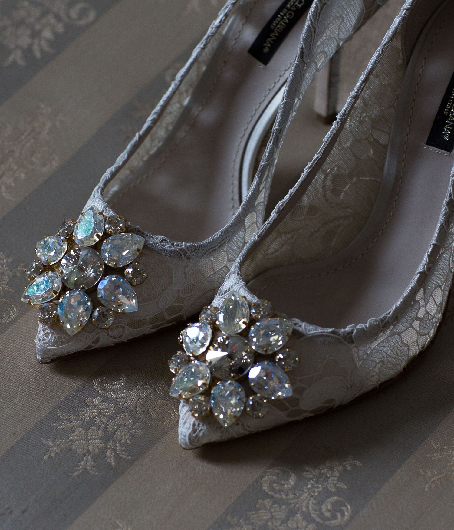 Elegant gray lace heels with jeweled embellishments displayed in a sequence.